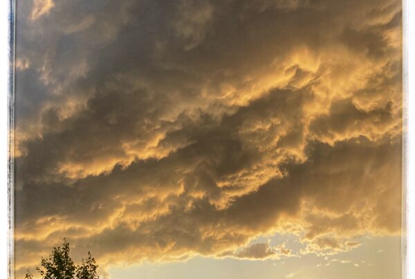 Heavy storm clouds over a setting sun