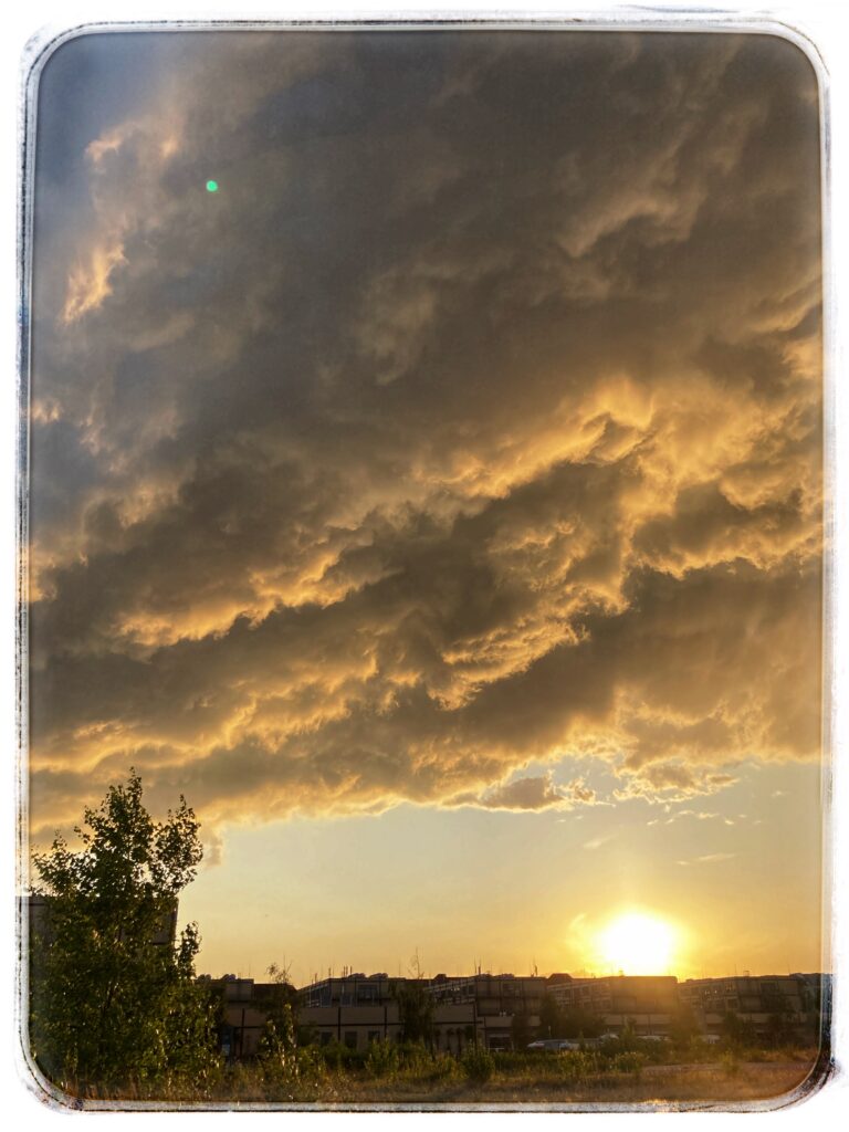 Heavy storm clouds over a setting sun