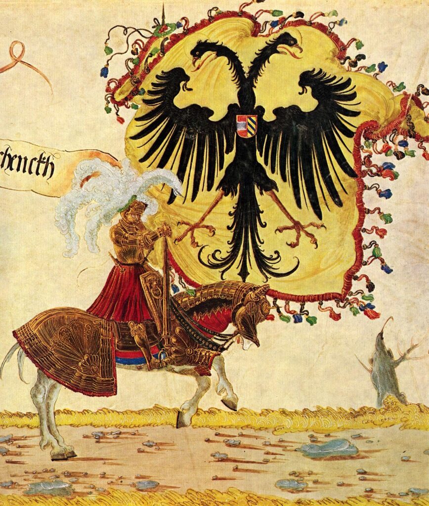 A painting by Albrecht Altdorfer depicting Emperor Maximilian I dressed in golden armour riding a warhorse with gold barding. Behind him is the Imperial Banner, a two-headed black eagle on a yellow background. The flag is bordered in crimson with a fringe of red, green, and blue tassels.